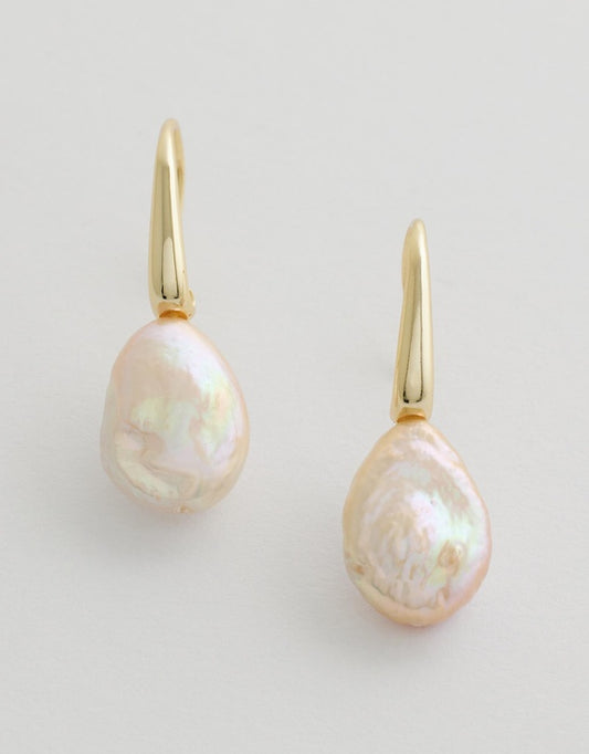 Aria Pearl Earrings with gold hooks on a light background