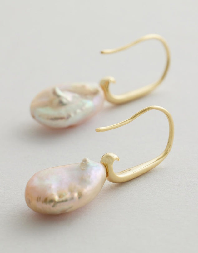 Aria Pearl Earrings with pink pearls on a light gray background