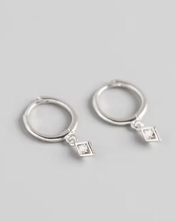 Ava Diamond Huggies - Silver on beige back ground