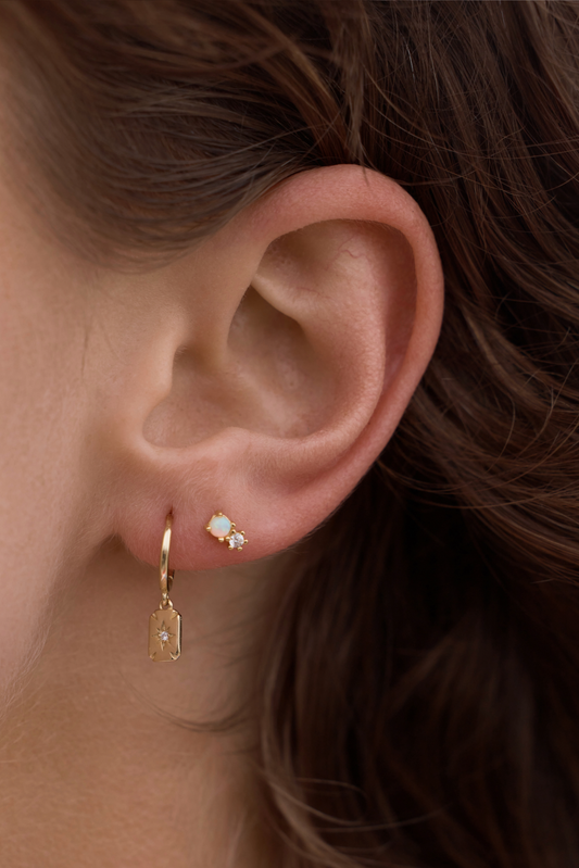 Milly Studs - White Opal on women's ear