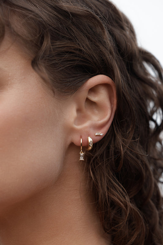 Rita Huggies - Clear & Gold close up on womens ear