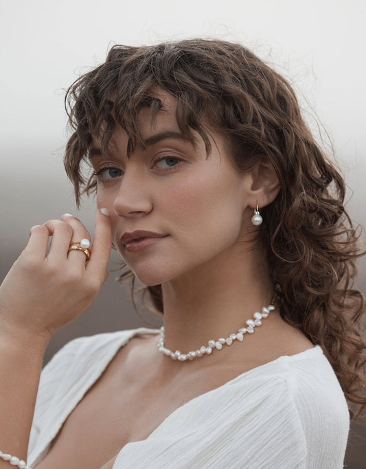 Valora Pearl Earrings on model from a distance