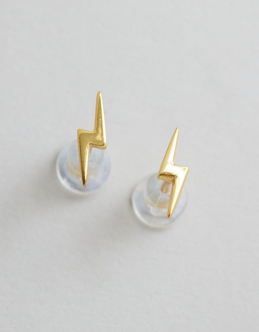 Lightning Bolt Studs - Gold flat lay on grey background