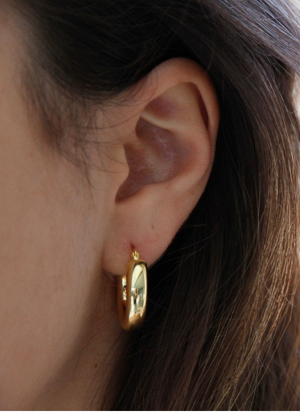 Indie Hoops - Gold earrings on a womens ear