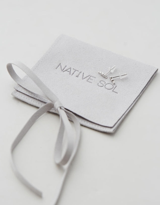 Lily Studs - Silver flat lay on jewellery pouch