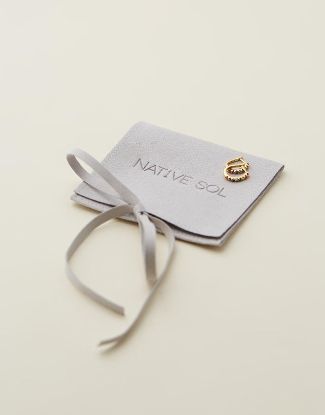 Rio Rainbow Huggies laid out on branded jewellery pouch