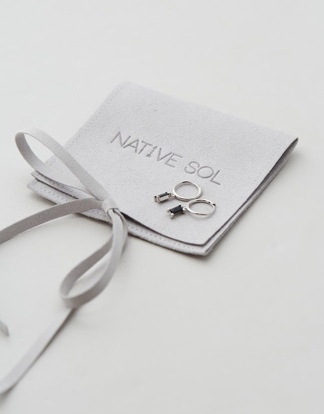 Rita Huggies - Onyx & Silver earrings laid out on jewellery pouch