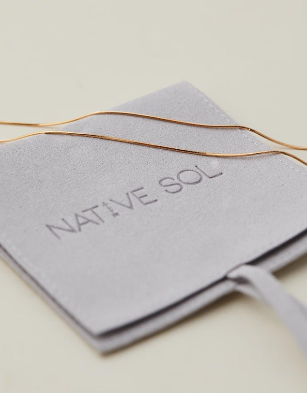 Snake Chain gold laid out on the branded packaging