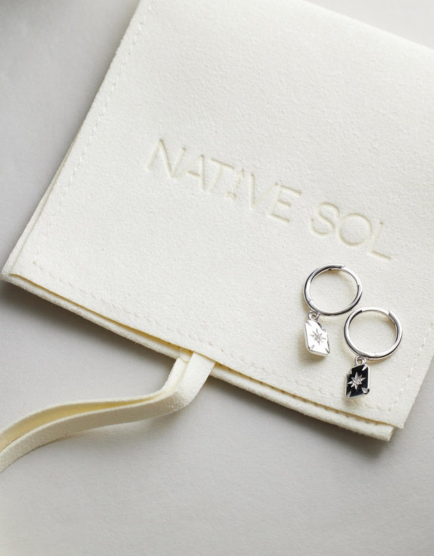 Ace Diamond Huggies - Silver on top of jewellery pouch