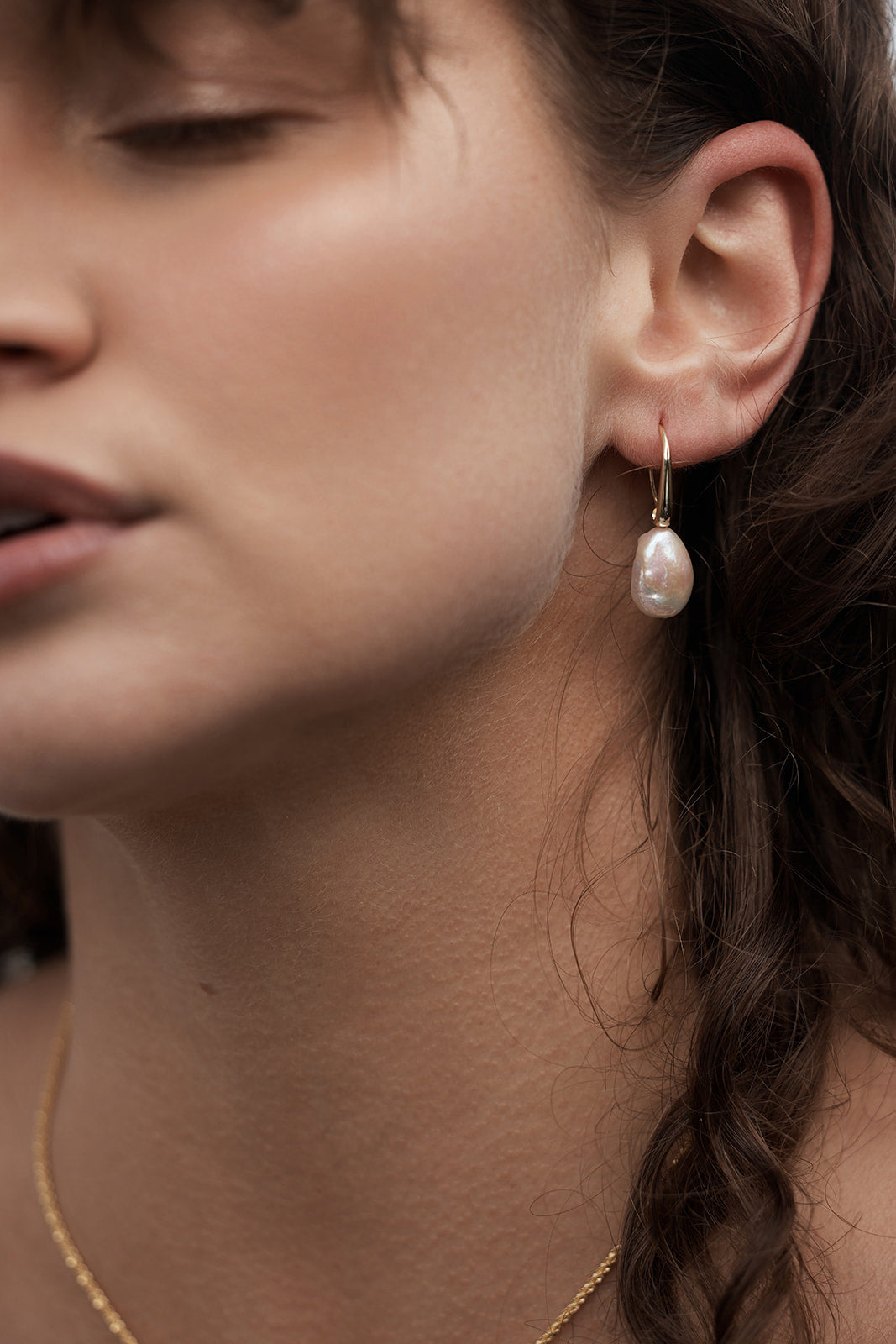 Aria Pearl Earrings Close-up of a woman wearing them on her ears