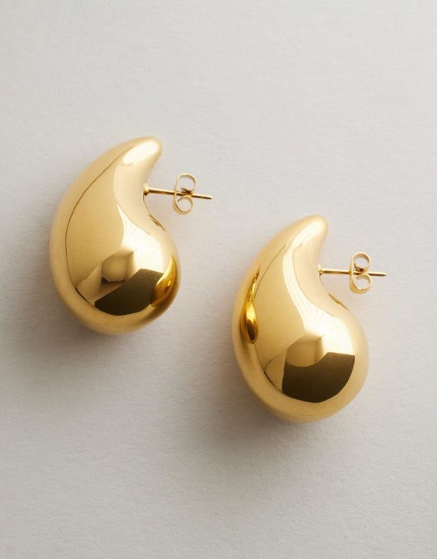 Arlow Teardrop Earrings - Gold flat lay on grey background