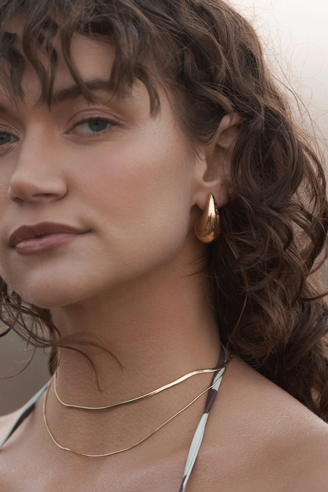 Arlow Teardrop Earrings - Gold on women's ear showing side of her face