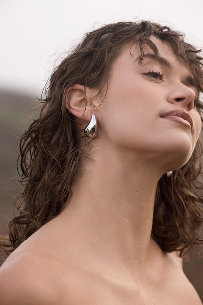 Arlow Teardrop Earrings - Silver close up on women's ear
