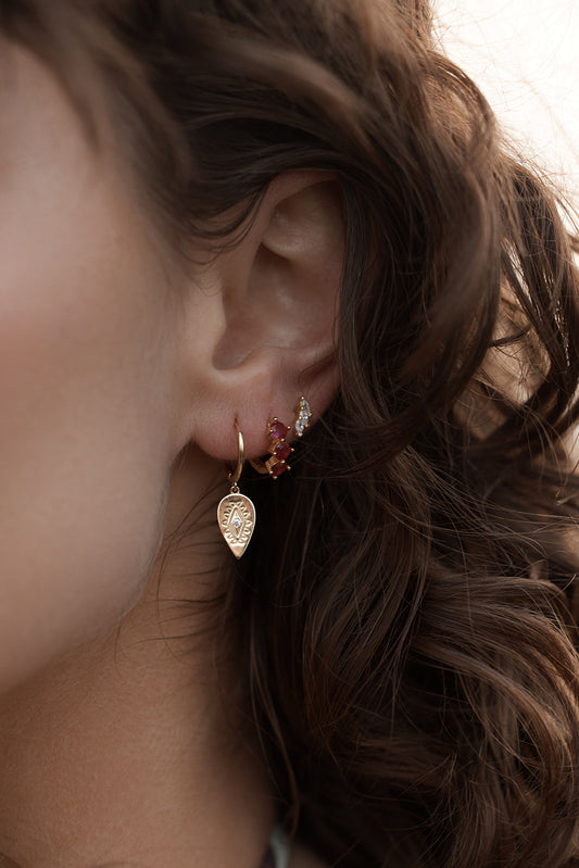 Aurora Huggie Earrings - Gold on model  styled with earring stack suggestions