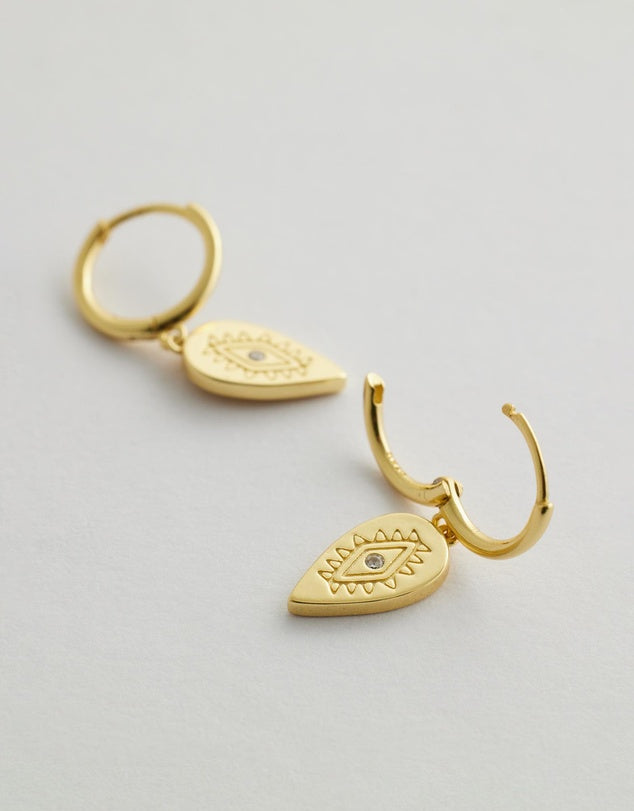 Aurora Huggie Earrings - Gold flay lay side view