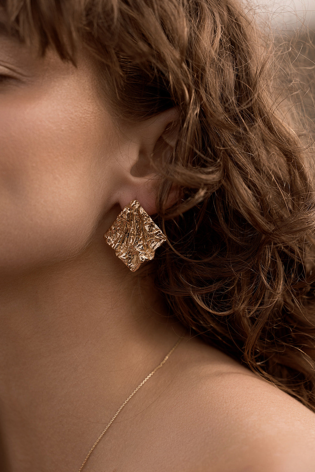 Belle Statement Earrings close up on ear of model