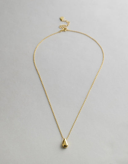 Gold Capri Teardrop Necklace with a teardrop pendant on a light gray background