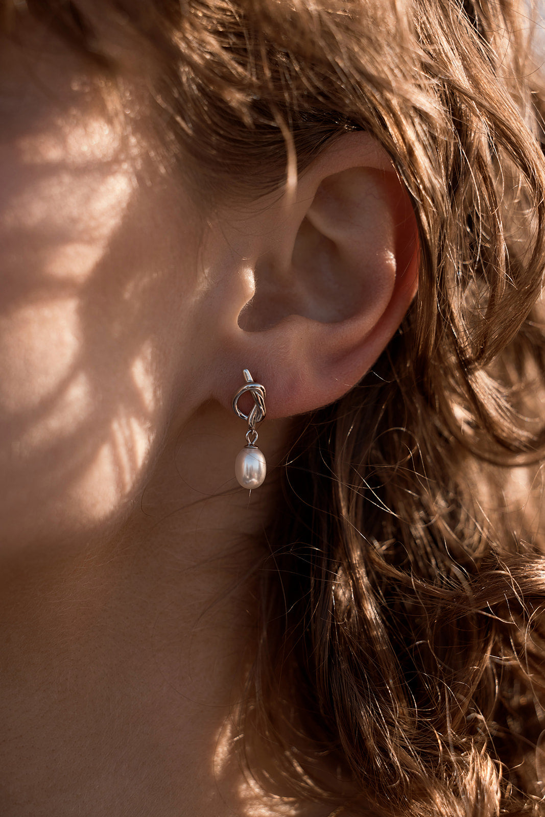 Chloe Pearl Studs - Gold on a women's ear