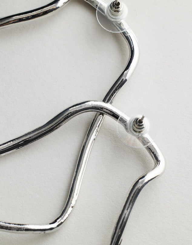 Harlow Earrings - Silver stethoscope on a light background