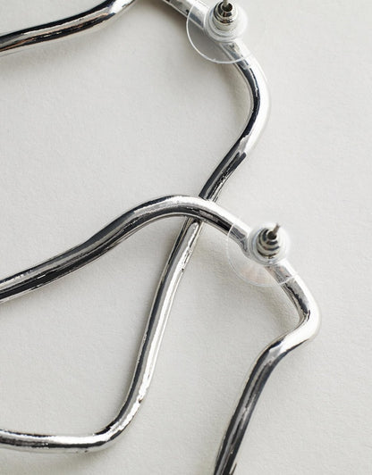 Harlow Earrings - Silver stethoscope on a light background