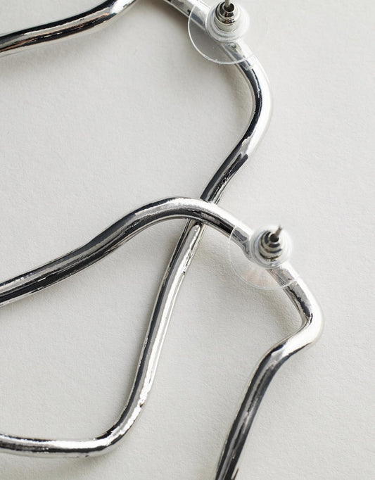 Harlow Earrings - Silver stethoscope on a light background