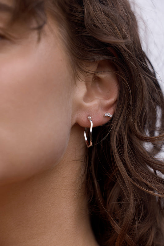 Lani Wave Hoops - Silver Close-up on an ear