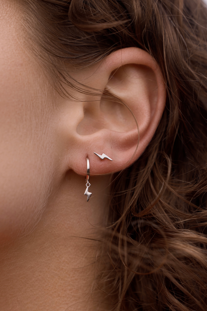 Lightning Bolt Studs - Silver close up on women's ear