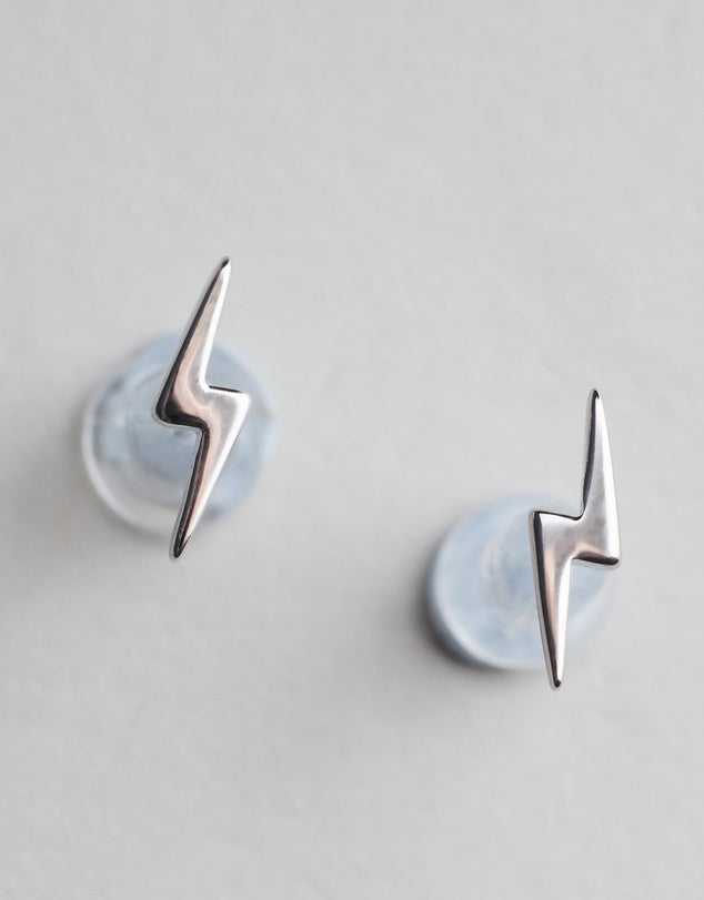 Lightning Bolt Studs - Silver flat lay on grey background