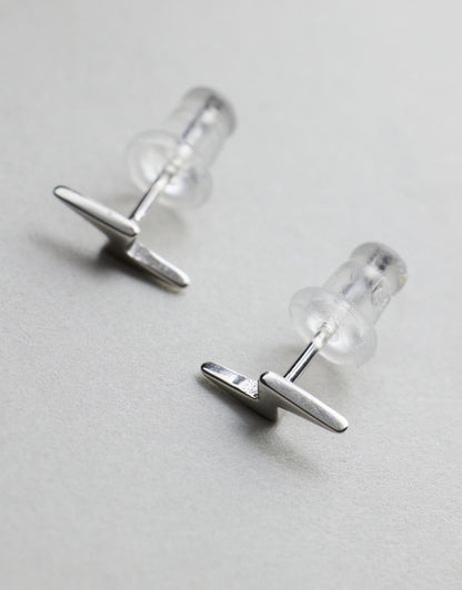 Lightning Bolt Studs - Silver flat lay side angle on grey background