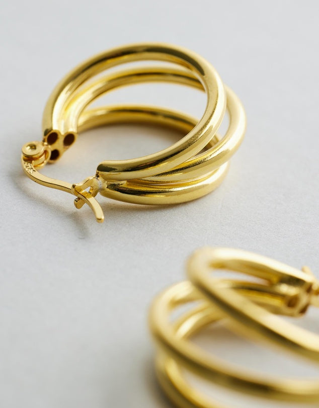 London Hoops - Gold earrings on a light gray background