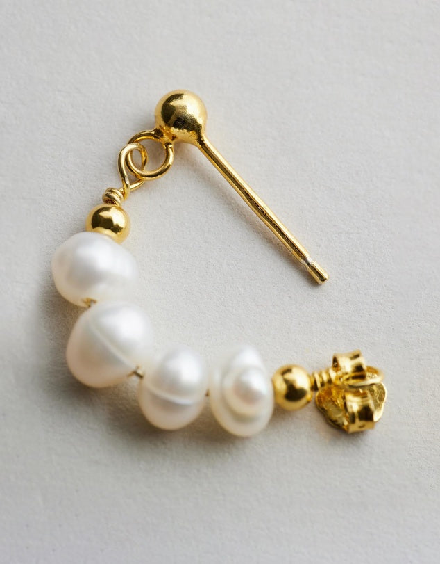 Mickie Pearl Hoop Earrings - Gold close up of one earring on grey background