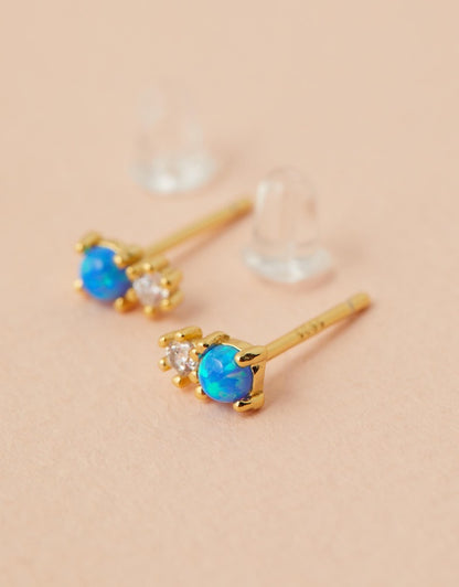 Milly Studs - Blue Opal close up side angle on pink background