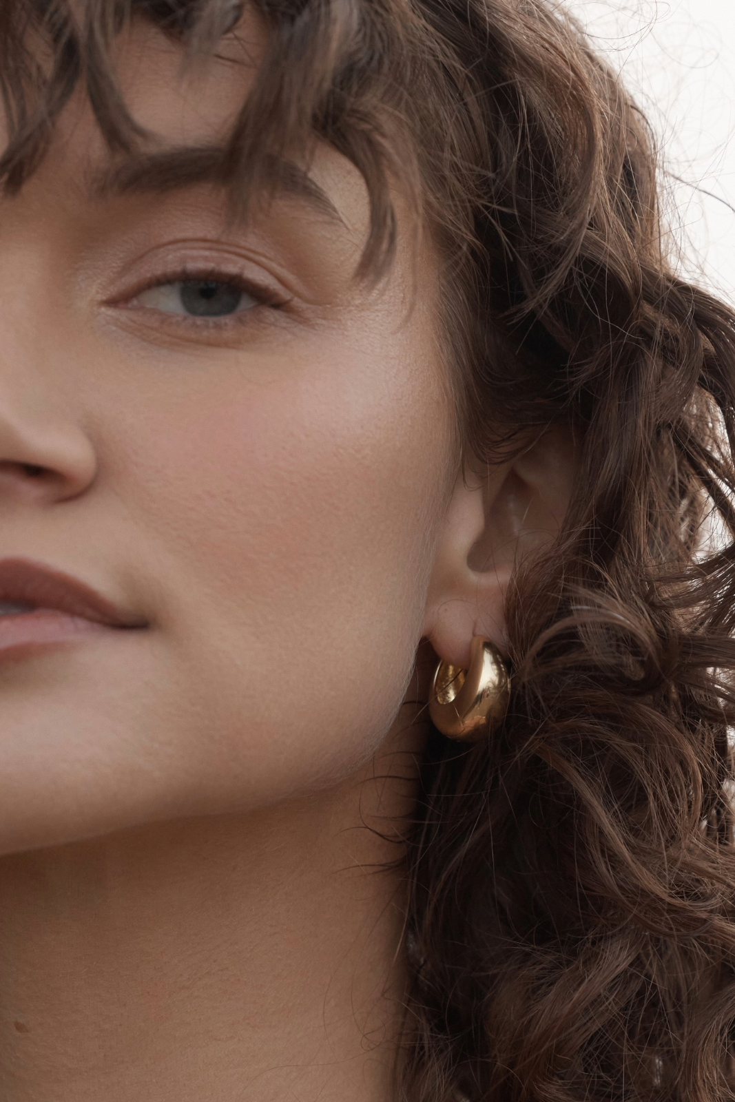 Mimi Hoops - Gold close up of women's face and ear