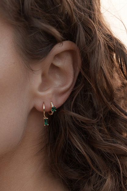 Nikki Emerald Huggies - Gold close up on women's ear