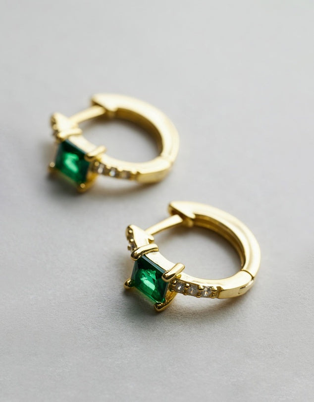 Nikki gold emerald hoops, flat lay close up
