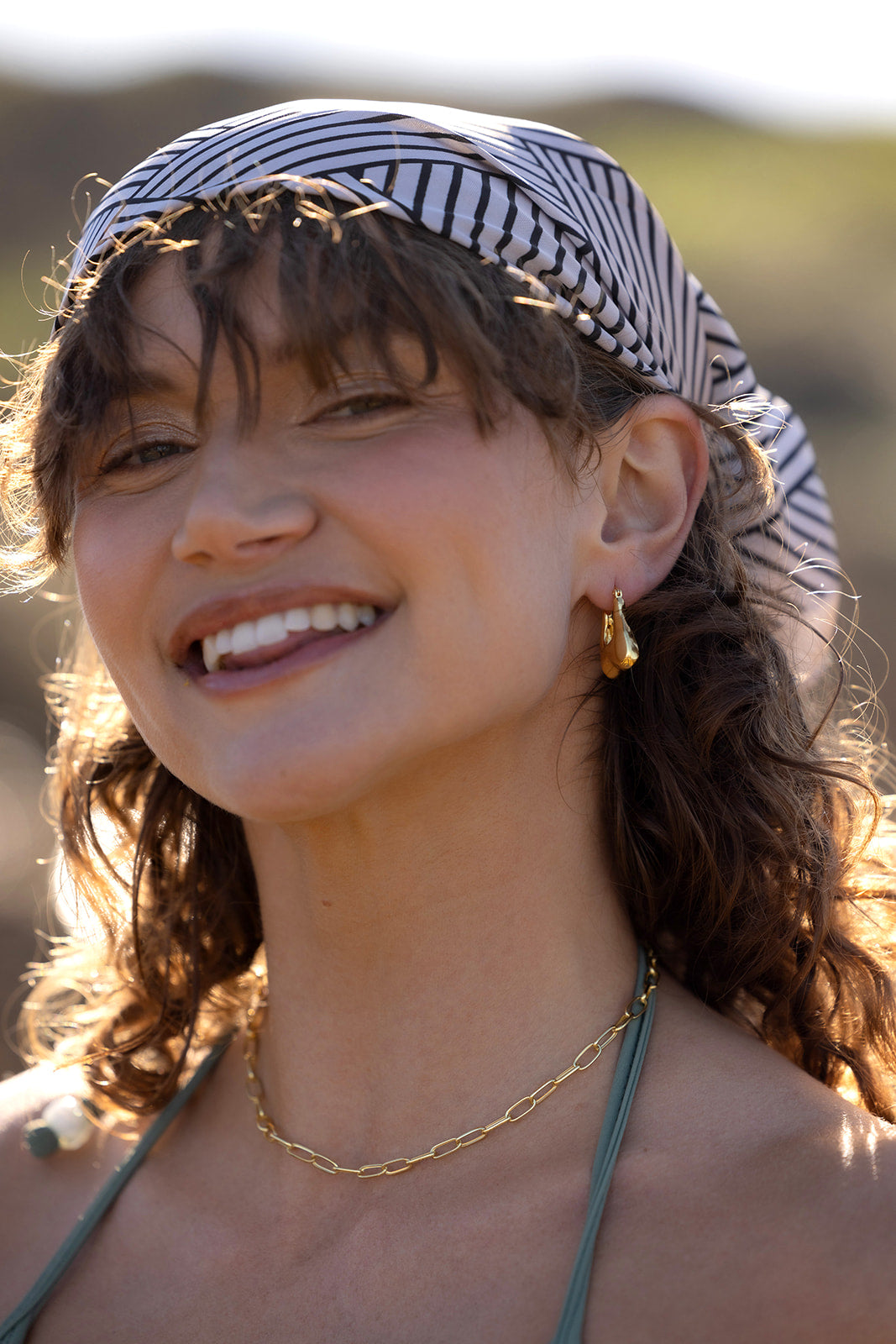 Nina Hoops - Gold head shot of women wearing earrings