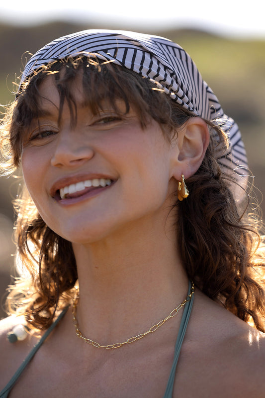 Nina Hoops - Gold head shot of women wearing earrings