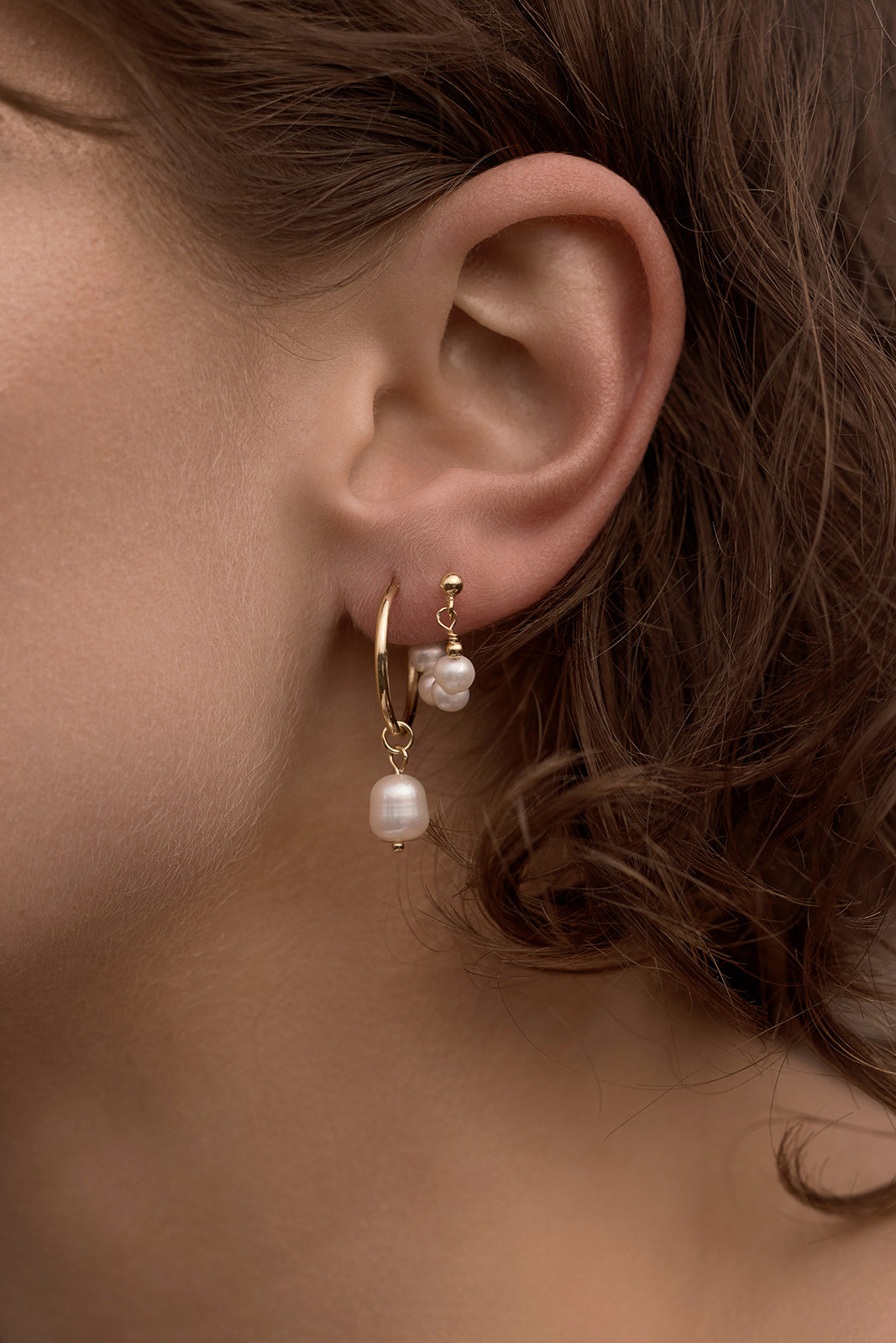 Oakley Pearl Hoops - Gold close up on womens ear