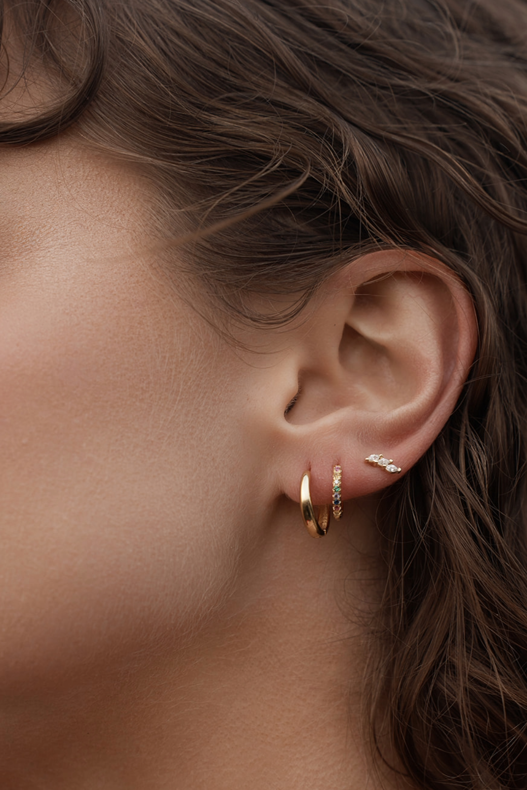 Close-up of Rio Rainbow Huggies on womens ear