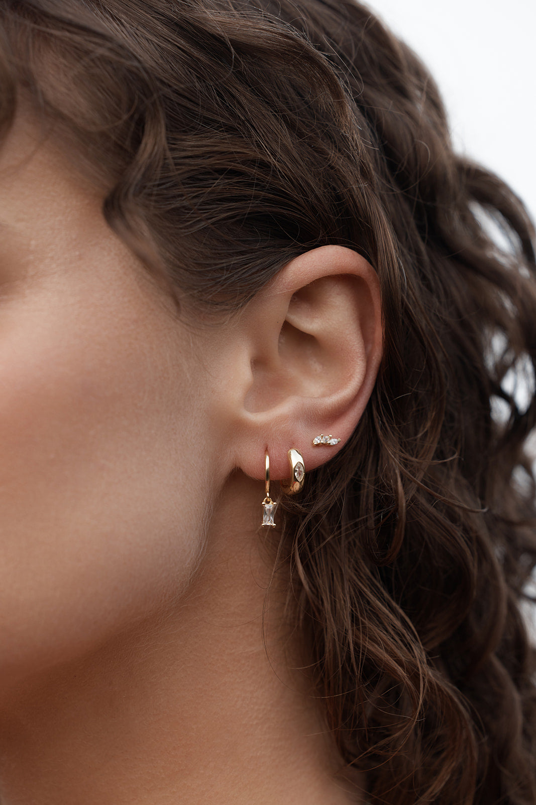 Rita Huggies - Clear & Gold close up on womens ear