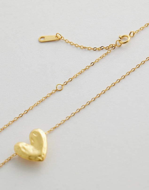 Rivellia Heart Necklace close up heart flat lay