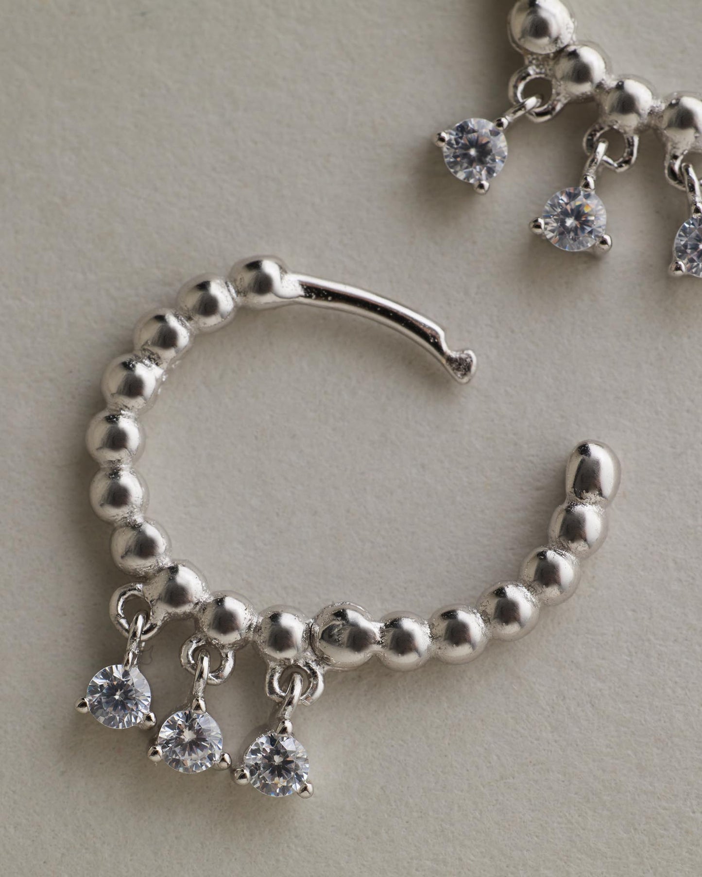 Sage Huggies - Silver flay lay on grey background