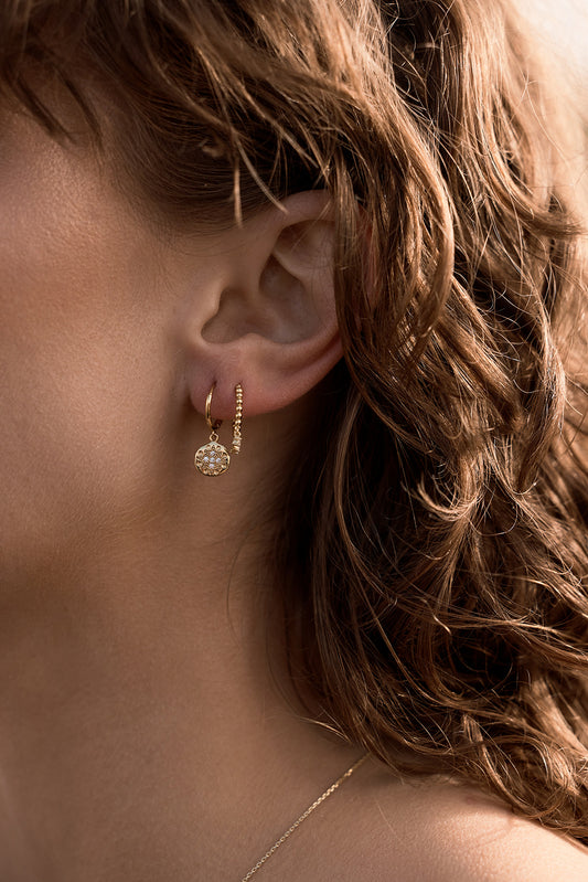 Seraphis Huggie Earrings - Gold on model close up