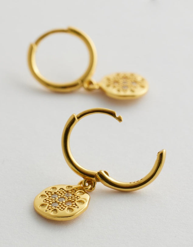 Seraphis Huggie Earrings - Gold flay lay side view