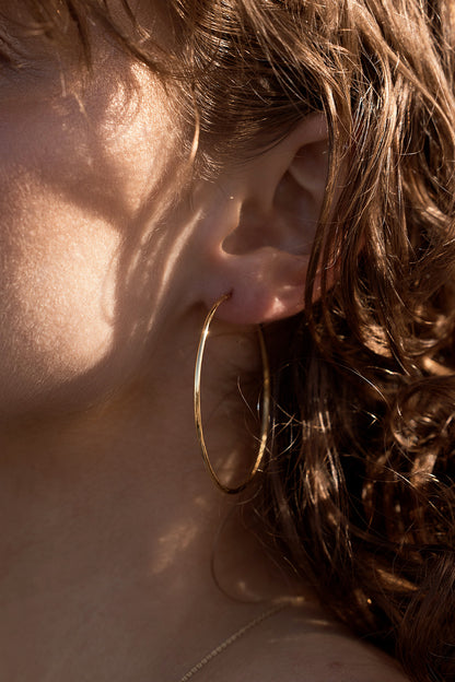 Solara Hoop Earrings on models ears close up