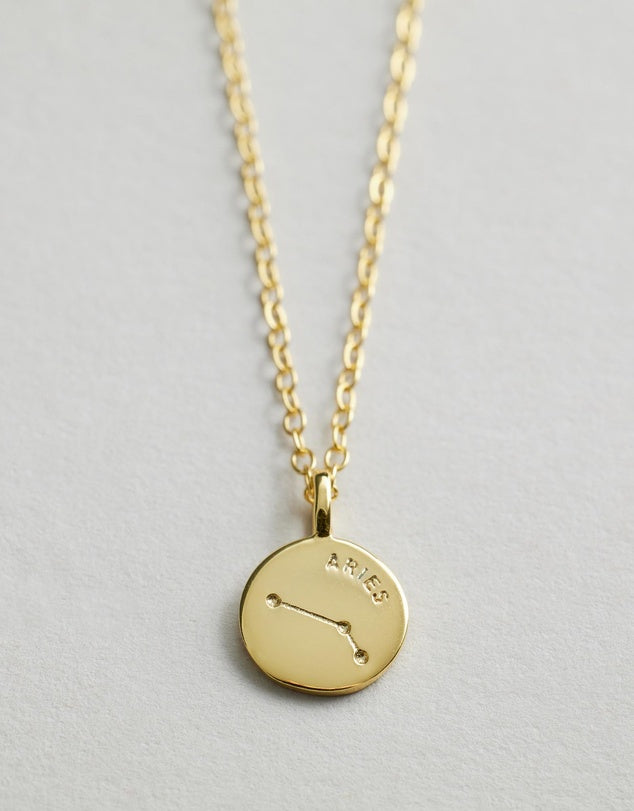 Starsign_Necklace with a round pendant featuring the constellation Aries on a light gray background