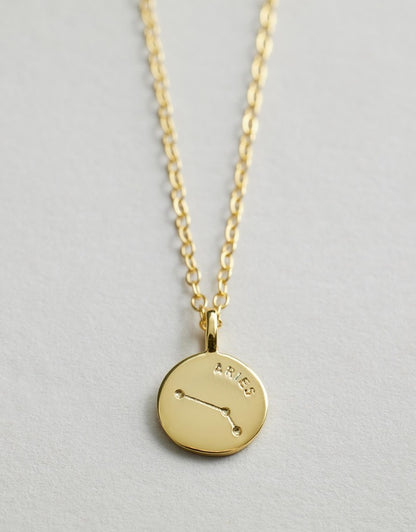 Starsign_Necklace with a round pendant featuring the constellation Aries on a light gray background