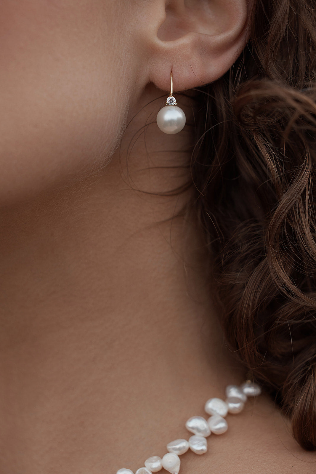 Valora Pearl Earrings close up on model ears