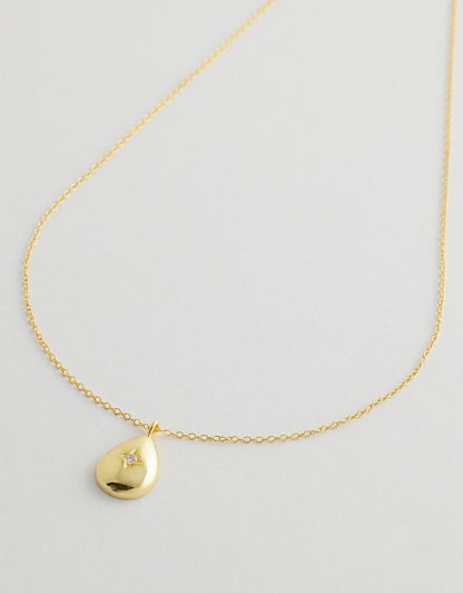 Virelia Teardrop Necklace close up pendant flat lay