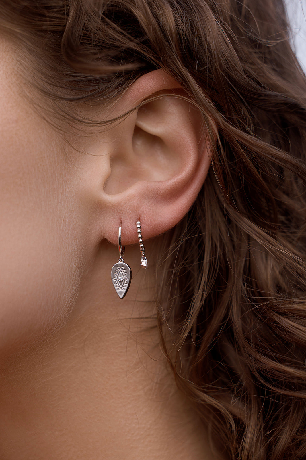 aurora huggie earrings silver model ear close up